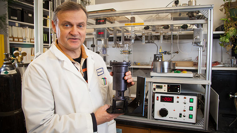 Dr. Nikolay N. Gerasimchuk, Distinguished Professor of chemistry and biochemistry, holds up a piece of equipment in his lab.