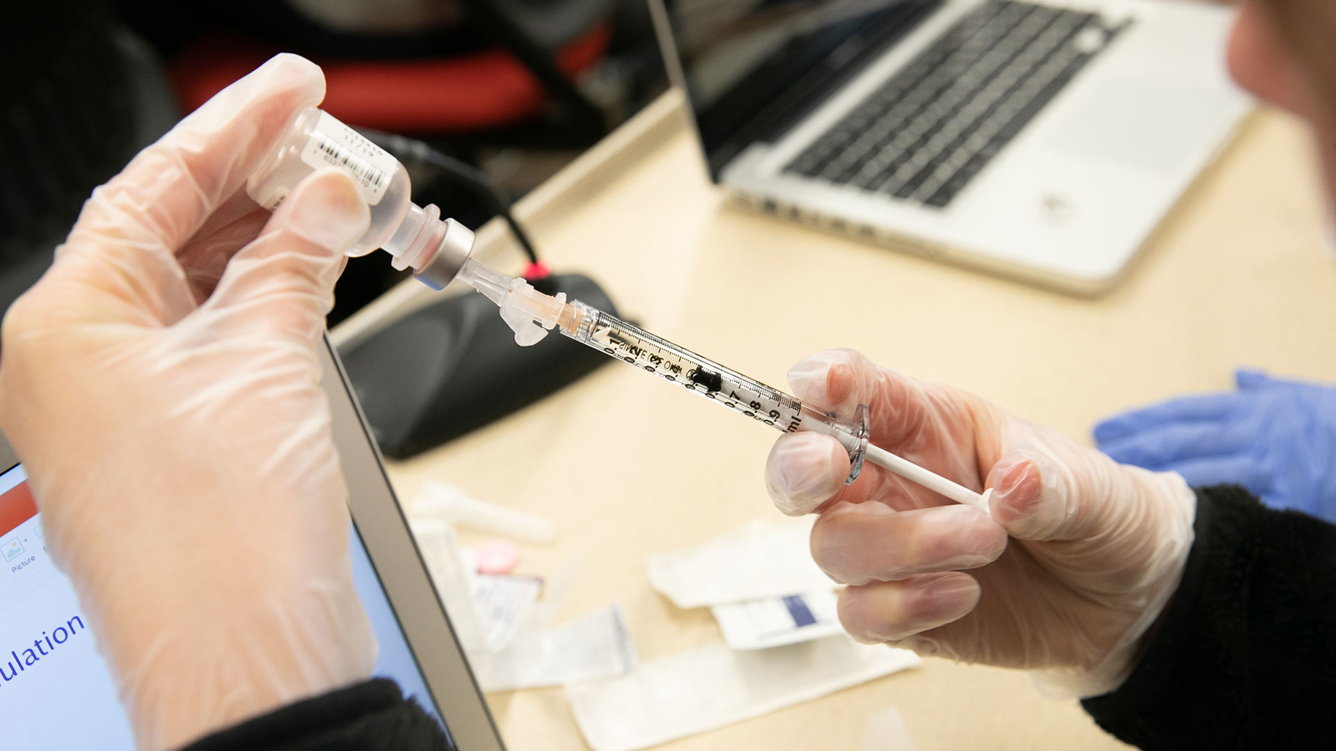 Student practicing vaccine shots.