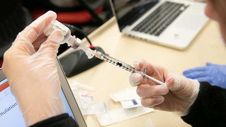 Student practicing vaccine shots.