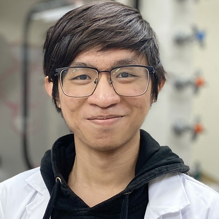 Chemistry student Joe Truong wears his lab coat